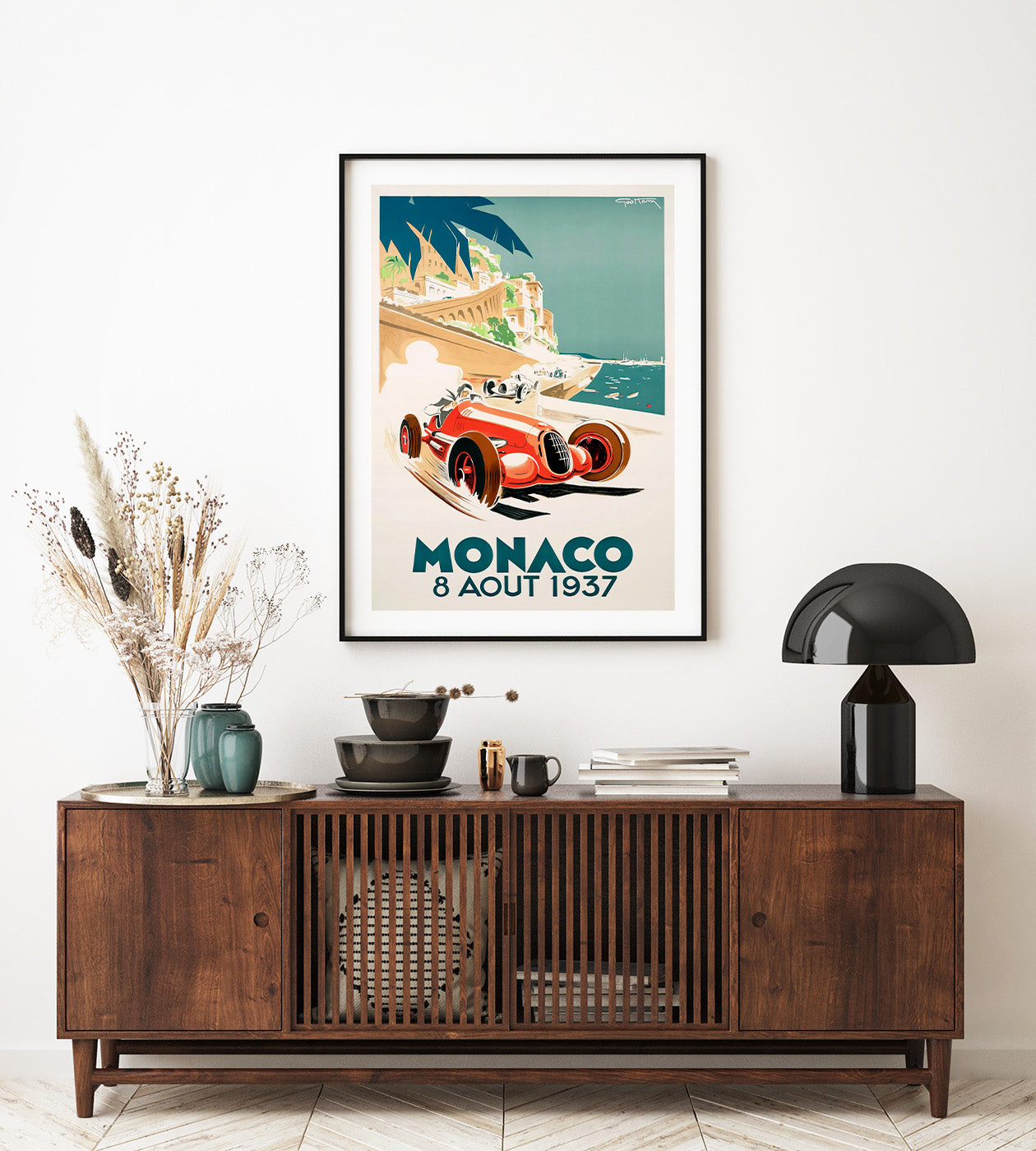 A red race car with the Monaco city in the background. Monaco written in large letters.