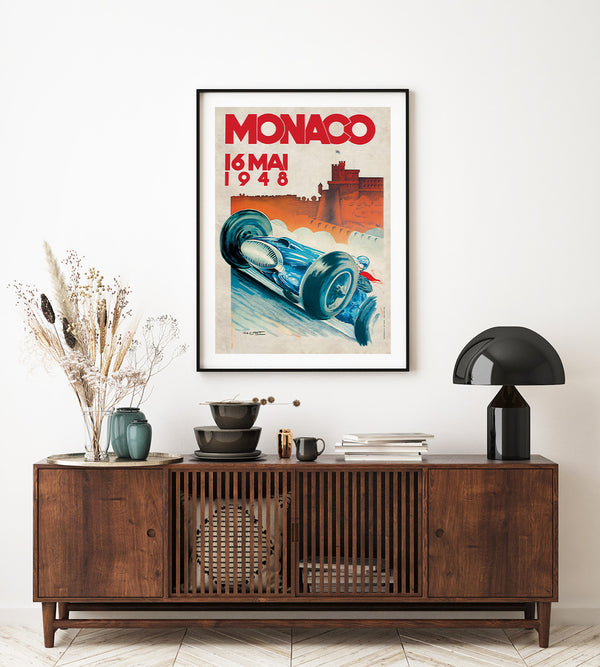 A blue race car in a vintage styled illustration. Monaco written with red letters on a light background