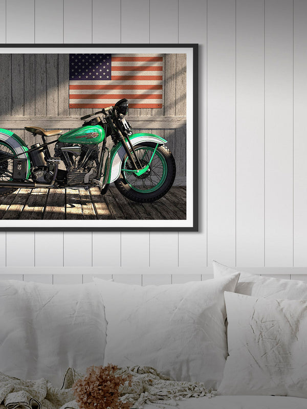 Picture showing a framed classic Harley Davidson hanging on the wall in an home environment